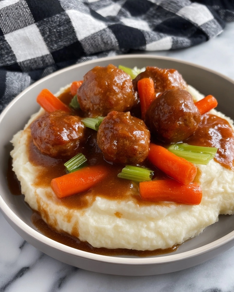 The image shows a dish with two main layers on a white plate. The bottom layer is a smooth, creamy white mashed potato base with a soft texture. On top, there is a rich brown gravy that covers several brown meatballs, glossy with sauce. Bright orange baby carrots and small pieces of green celery are scattered among the meatballs, adding color and texture contrast. The plate sits on a white marbled surface and a black and white checkered cloth is in the background. photo taken with an iphone --ar 4:5 --v 7