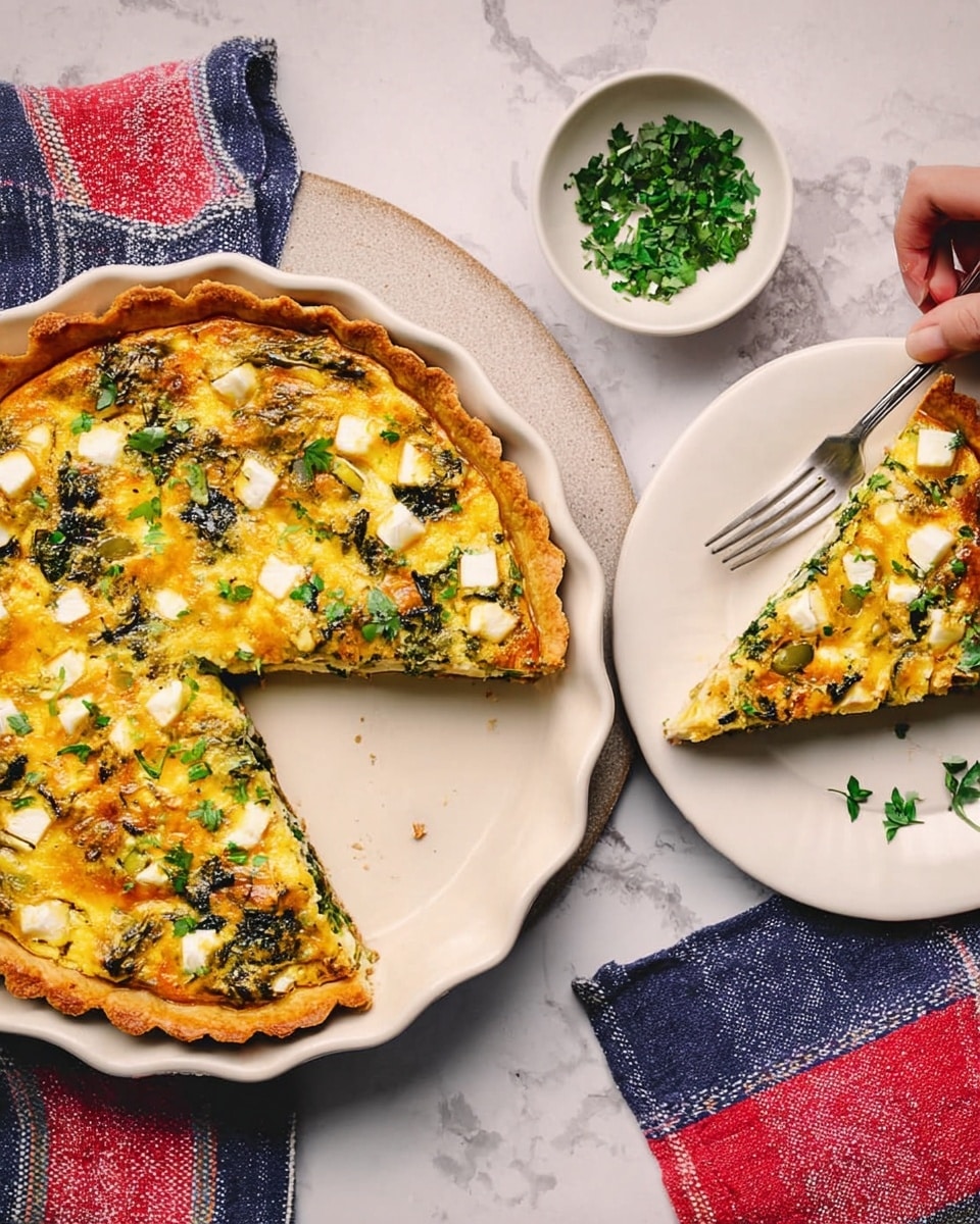 A white dish holds a baked quiche with a golden crust, filled with a rich yellow egg base mixed with green leafy vegetables and small white cheese cubes scattered on top, showing a slightly browned texture from baking. One slice is cut out from the dish, revealing the layers inside with visible soft vegetables and cheese. Next to it, a white plate has a single slice of the quiche with some green herbs sprinkled on top. A small white bowl with chopped green herbs is placed above, and a woman's hand is visible holding a fork resting on a red, white, and blue cloth, all set on a white marbled surface. Photo taken with an iphone --ar 4:5 --v 7