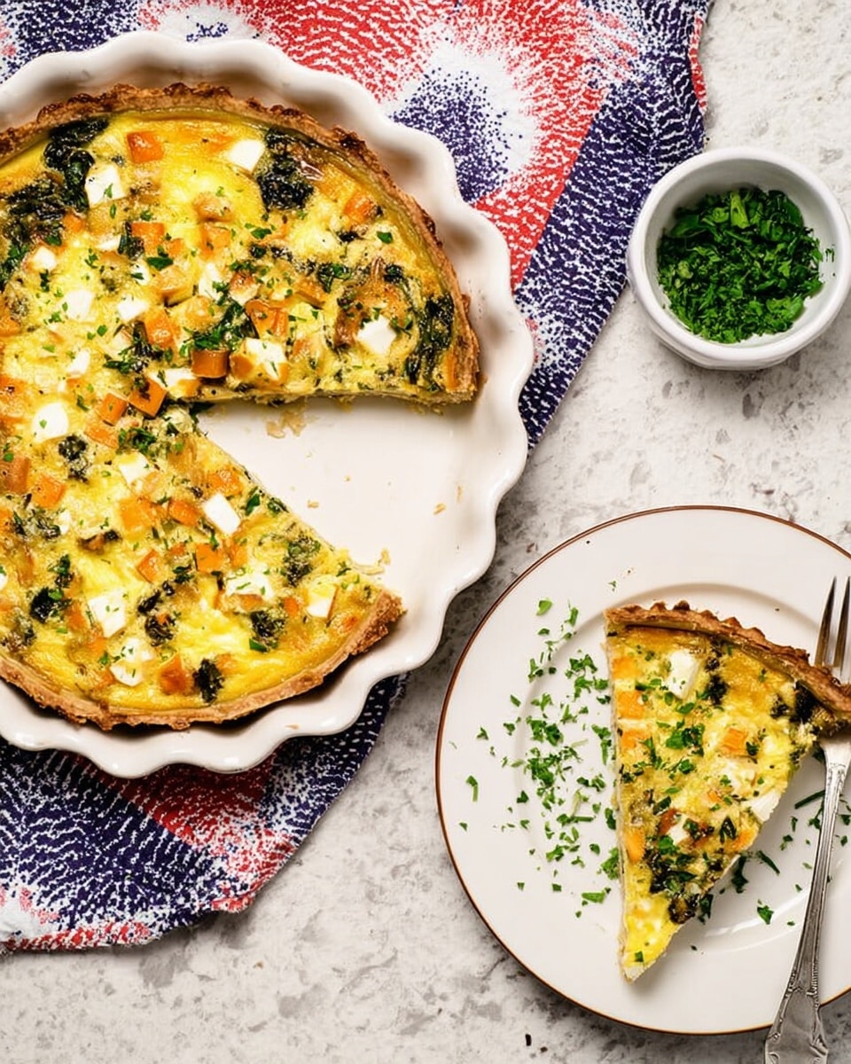 The image shows a round quiche with one slice taken out, placed on a white scalloped ceramic dish on a white marbled surface. The quiche has a golden crust on the edge, with a yellow creamy egg filling mixed with green leafy vegetables, small orange chunks, and white cubes spread evenly on top, creating a colorful, textured look. The missing slice is on a white plate nearby, with some chopped green herbs sprinkled over both the quiche and the plate. Next to the dish is a small white bowl filled with finely chopped green herbs. A woman's hand with a fork is near the top left corner, resting on a red, white, and blue patterned cloth. The overall feeling is warm and fresh. photo taken with an iphone --ar 4:5 --v 7
