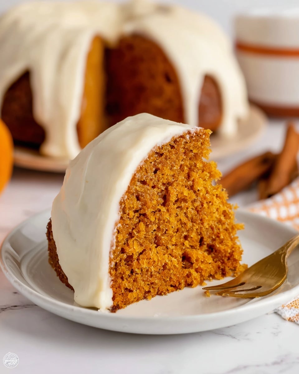 A bundt cake with a rich brown color sits on a white plate, topped with thick, creamy white icing drizzled in smooth, even lines that run from the top center down the sides of the cake. The cake is surrounded by golden forks and a white marbled surface underneath, with a hint of an orange-striped cloth in the corner, creating a warm and inviting scene. The photo is taken with an iphone --ar 4:5 --v 7