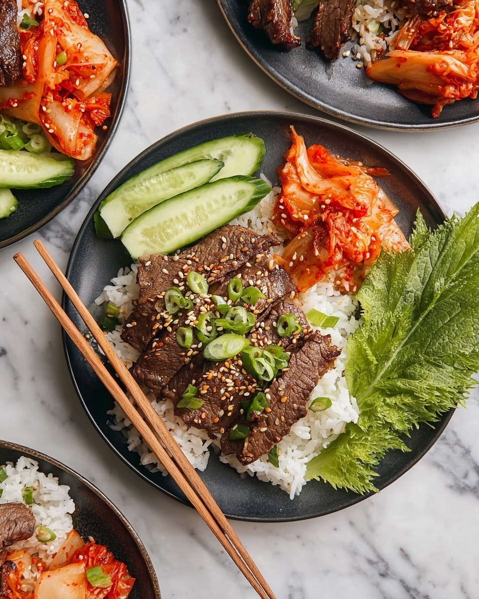 A black plate is filled with a base layer of white rice, topped with several slices of dark brown grilled beef sprinkled with light tan sesame seeds and sliced green onions. To the side, there are fresh cucumber sticks in light green with a smooth texture, along with bright red-orange kimchi that has a slightly wet and shredded look. A large, textured green leafy herb rests next to the rice, adding contrast. Two wooden chopsticks rest diagonally across the plate. The plate is placed on a white marbled surface with other similar plates partially visible nearby. Photo taken with an iphone --ar 4:5 --v 7